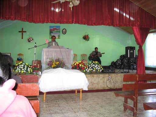 The Methodist Church minister playing guitar during singing